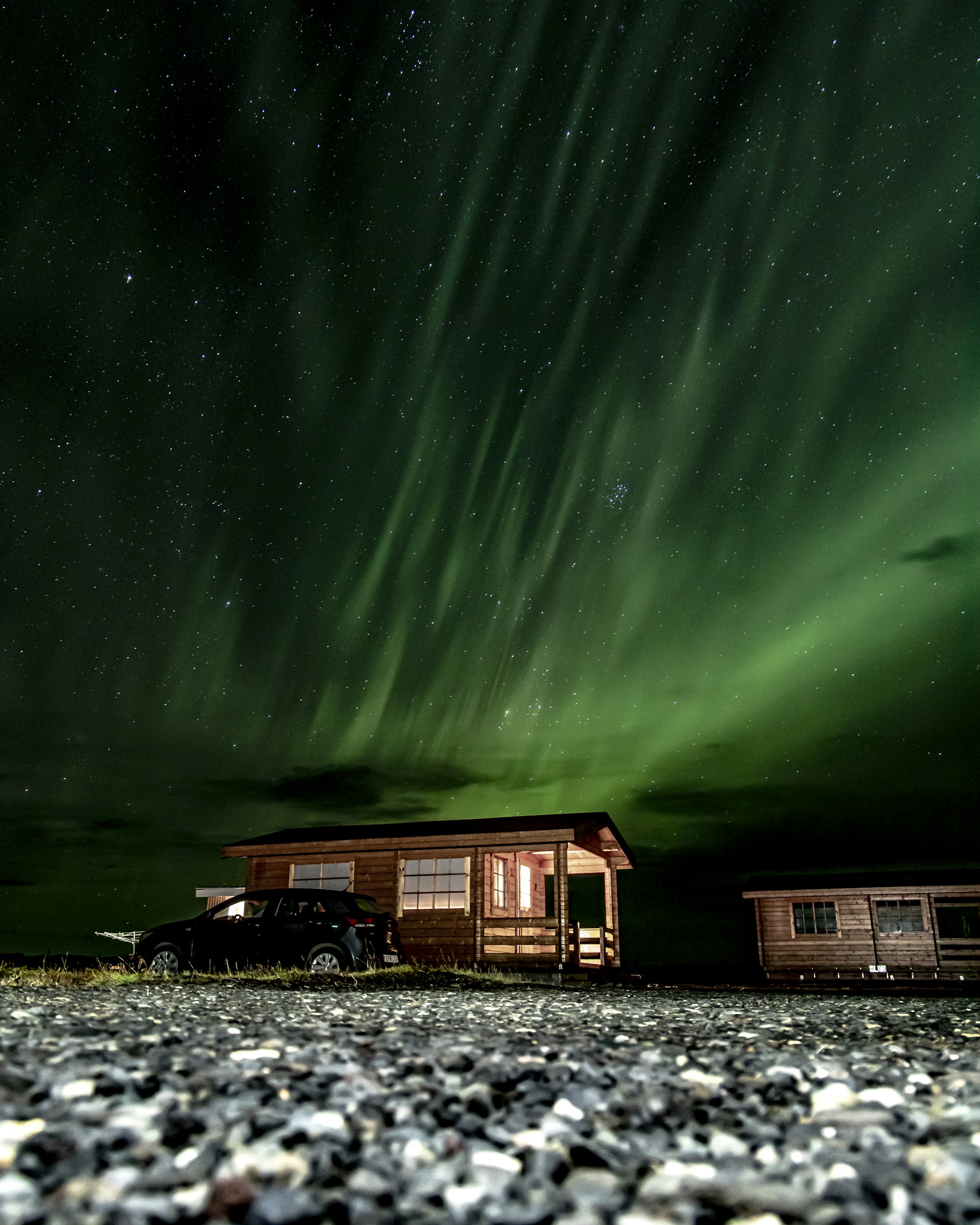 Northern lights over a cabin in Iceland