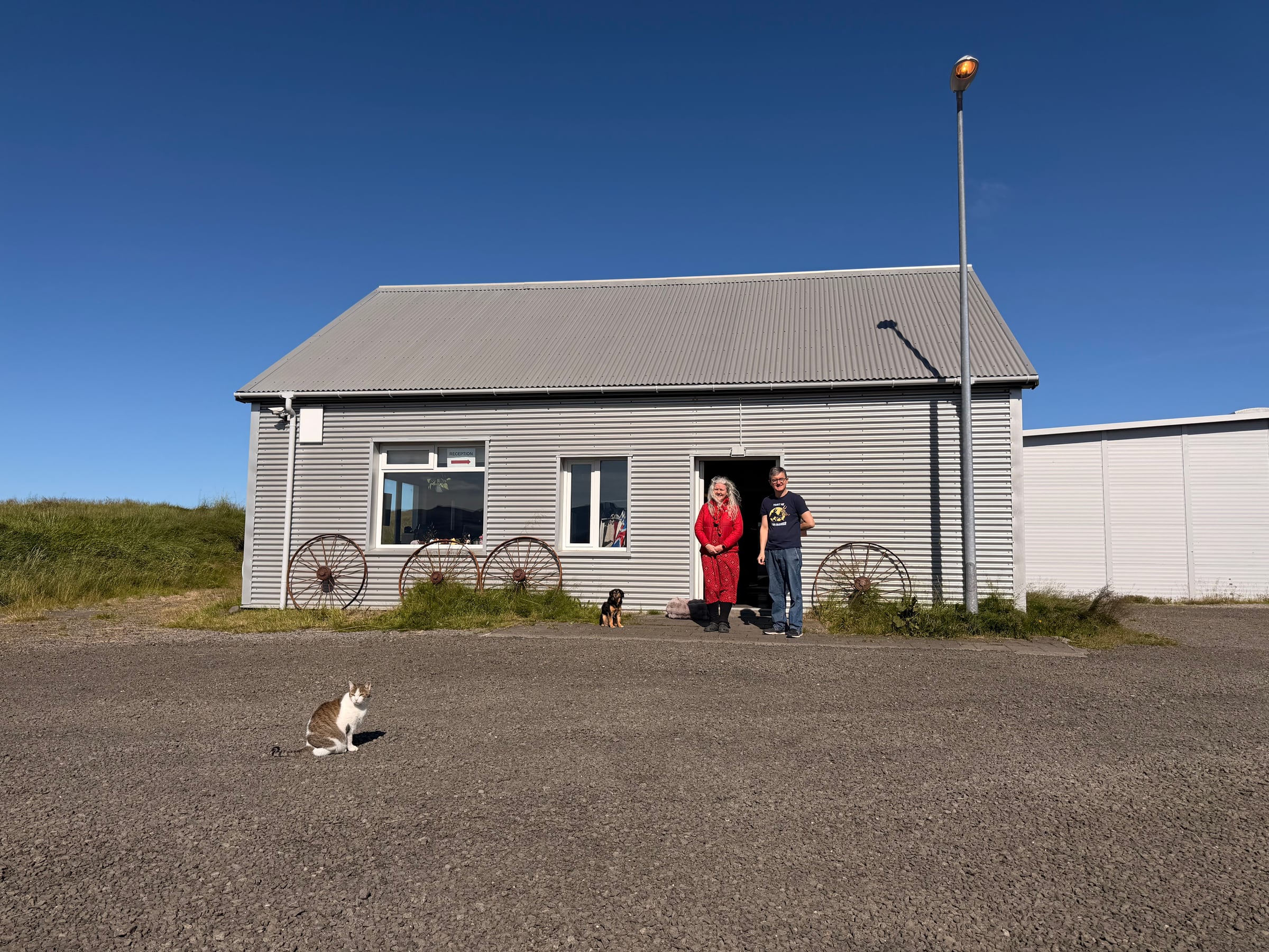 Sif and Duccio outside Lækjarkot with their dog Odinn and cat Mr. Rossi